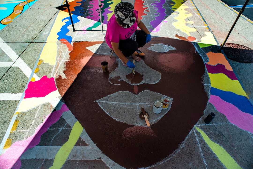 (Rick Egan  |  The Salt Lake Tribune)    Artist, Liz Lambson, works on the Black Lives Matter mural, on the south side of Salt Lake City Hall on Tuesday, Aug. 4, 2020.