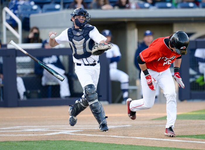 (Leah Hogsten  |  The Salt Lake Tribune) Utah's Shea Kramer tries to beat the pass of BYU's catcher David Clawson as Brigham Young University hosts University of Utah at Miller Park, Tuesday, April 24, 2018 in Provo.
