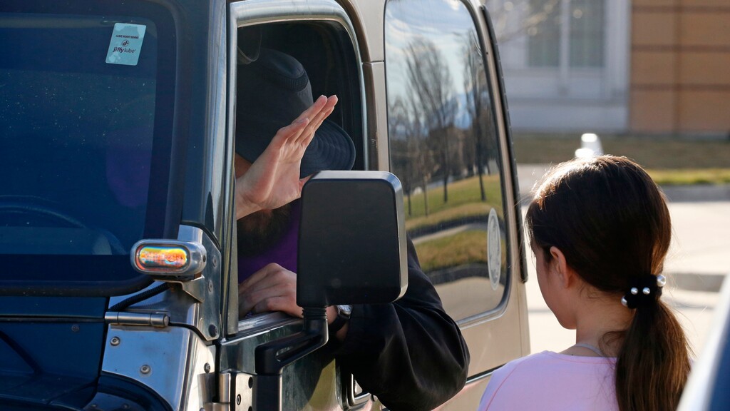 (Rick Bowmer | The Associated Press) The Rev. Stephen Tilley sits behind his steering wheel as he listens to the confession of girl during "Meet Me at the Jeep," for a drive-up confession Sunday, March 22, 2020, in Draper, Utah. With the threat of the new coronavirus closing churches, some Catholic priests in Utah offered to hear drive-up confessions.