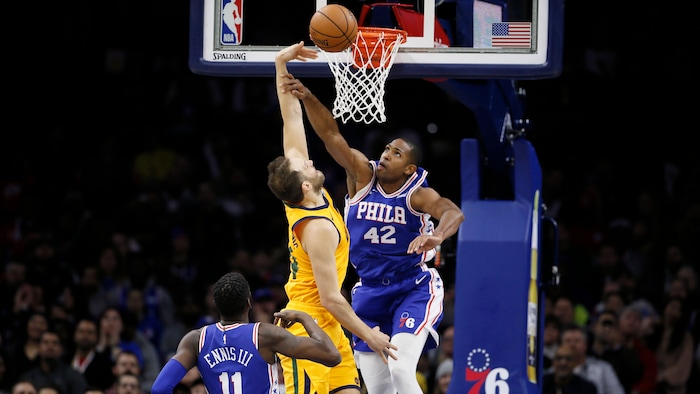 Philadelphia 76ers' Al Horford, right, blocks a shot by Utah Jazz's Bojan Bogdanovic, center, as 76ers' James Ennis III looks on during the first half of an NBA basketball game, Monday, Dec. 2, 2019, in Philadelphia. (AP Photo/Matt Slocum)