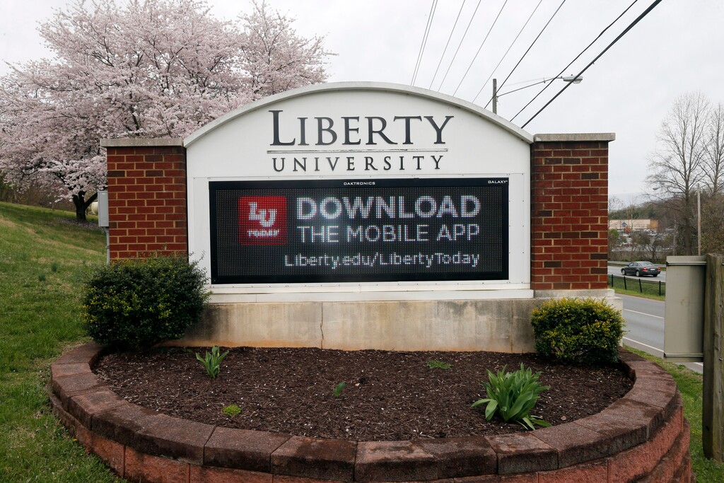 FILE - In this March 24, 2020 file photo, a sign marks the entrance to Liberty University, Tuesday March 24 , 2020, in Lynchburg, Va. (AP Photo/Steve Helber)