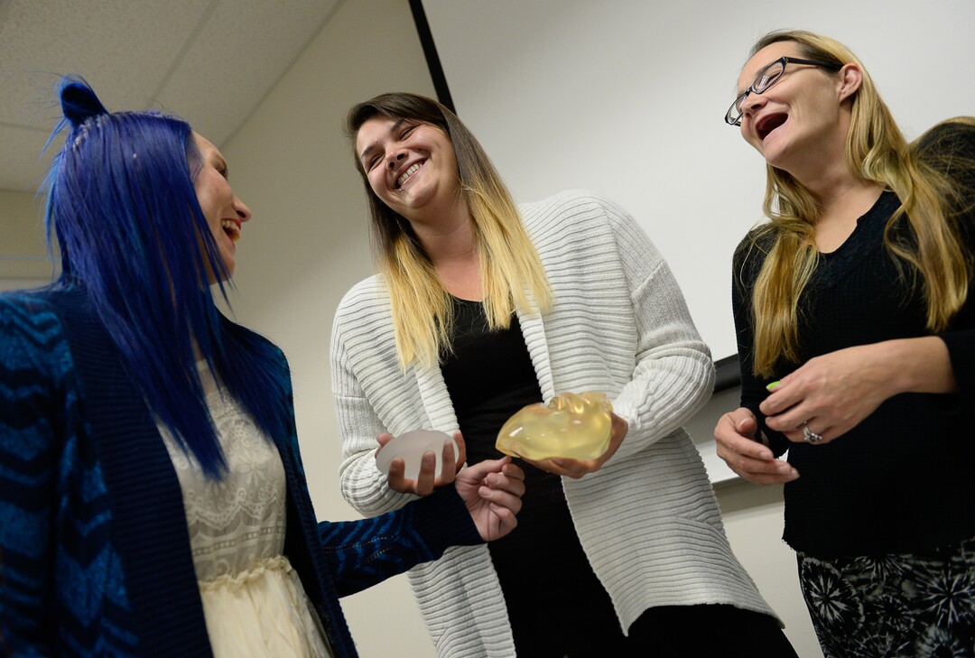 (Francisco Kjolseth  |  The Salt Lake Tribune)  Learning about medical devices and getting to hold breast implants, single mothers Katie Free, Heather Rice and Barbie Blood, from left, have a laugh as they participate in the Invest in You Too program, a 13-week course that helps single mothers build skills in medical manufacturing and job readiness to open the doors for employment. The students will graduate in November with hopes of landing high paying jobs to support their children and break their cycle of poverty.