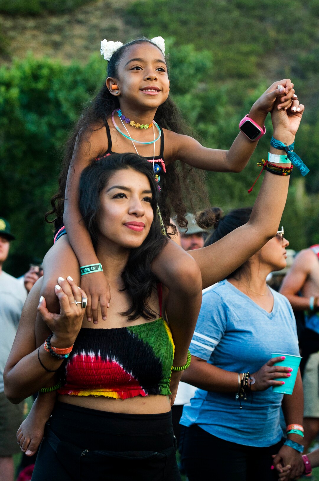 (Rick Egan  |  The Salt Lake Tribune)    Antoinette Flores, from Phoenix, AZ, holds 6-year-old Gabrielle Jones on her shoulders, as they dance to reggae music on the opening day of the 3-day Reggae Rise Up Festival at the Rivers Edge in Heber City, Friday, Aug. 24, 2018.