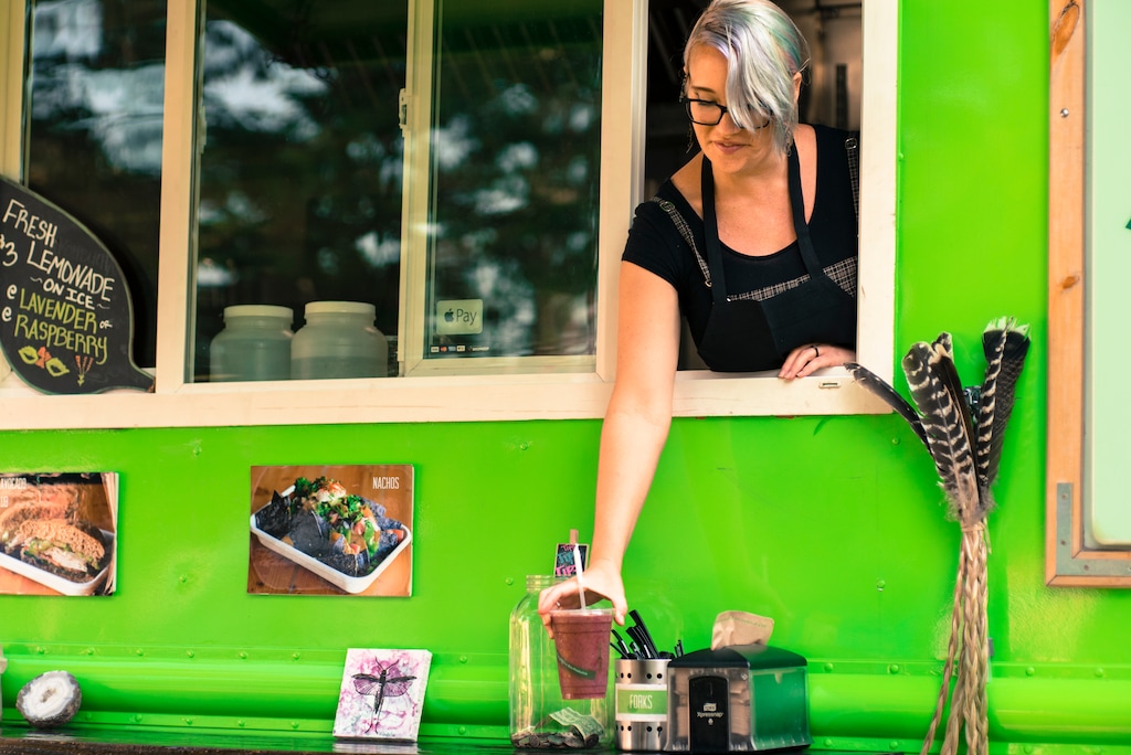 (Courtesy of Bobbie Henderson at Ginger's Garden Cafe and Ginger's Truck)  Bobbie Henderson, owner of Ginger's Truck, placing a smoothie on a table outside of the food truck. Ginger's is an extension of Ginger's Garden Cafe in Springville.