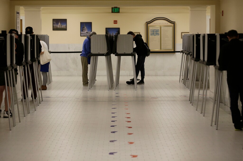 (Jeff Chiu | The Associated Press) In this June 7, 2016 file photo, voters cast ballots in voting booths at City Hall in San Francisco. San Francisco will become the first city in California and one of only a handful nationwide to allow noncitizens to vote in a local election in November. They’re only allowed to vote in the school board race.