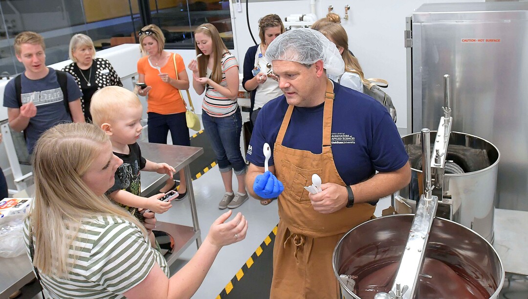 (Eli Lucero  |  The Herald Journal) Steve Shelton hands out samples during a public tour of the Aggie Chocolate Factory on Tuesday in Logan.
