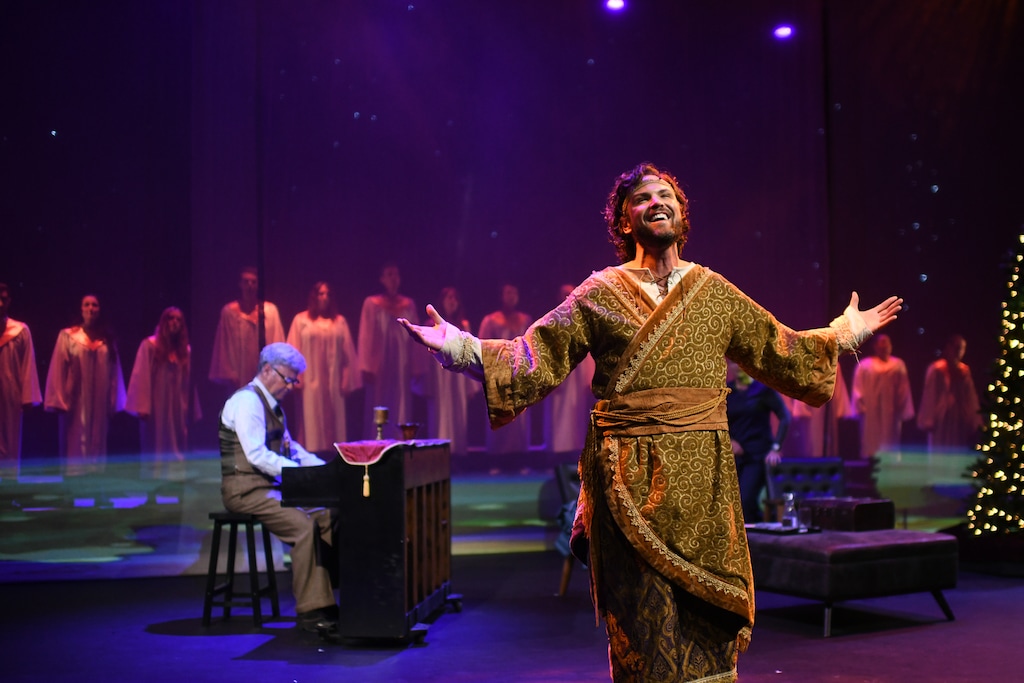 (Purdie Distribution) Jeff McLean, front, plays the innkeeper, describing the night he turned away Mary and Joseph, in the movie version of Michael McLean's "The Forgotten Carols." Michael is at the keyboard.