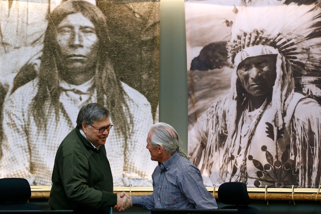(Patrick Semansky | AP) Attorney General William Barr greets Leonard Gray, vice chairman of the Confederated Salish and Kootenai Tribes council, before speaking at a council meeting, Friday, Nov. 22, 2019, on the Flathead Reservation in Pablo, Mont.