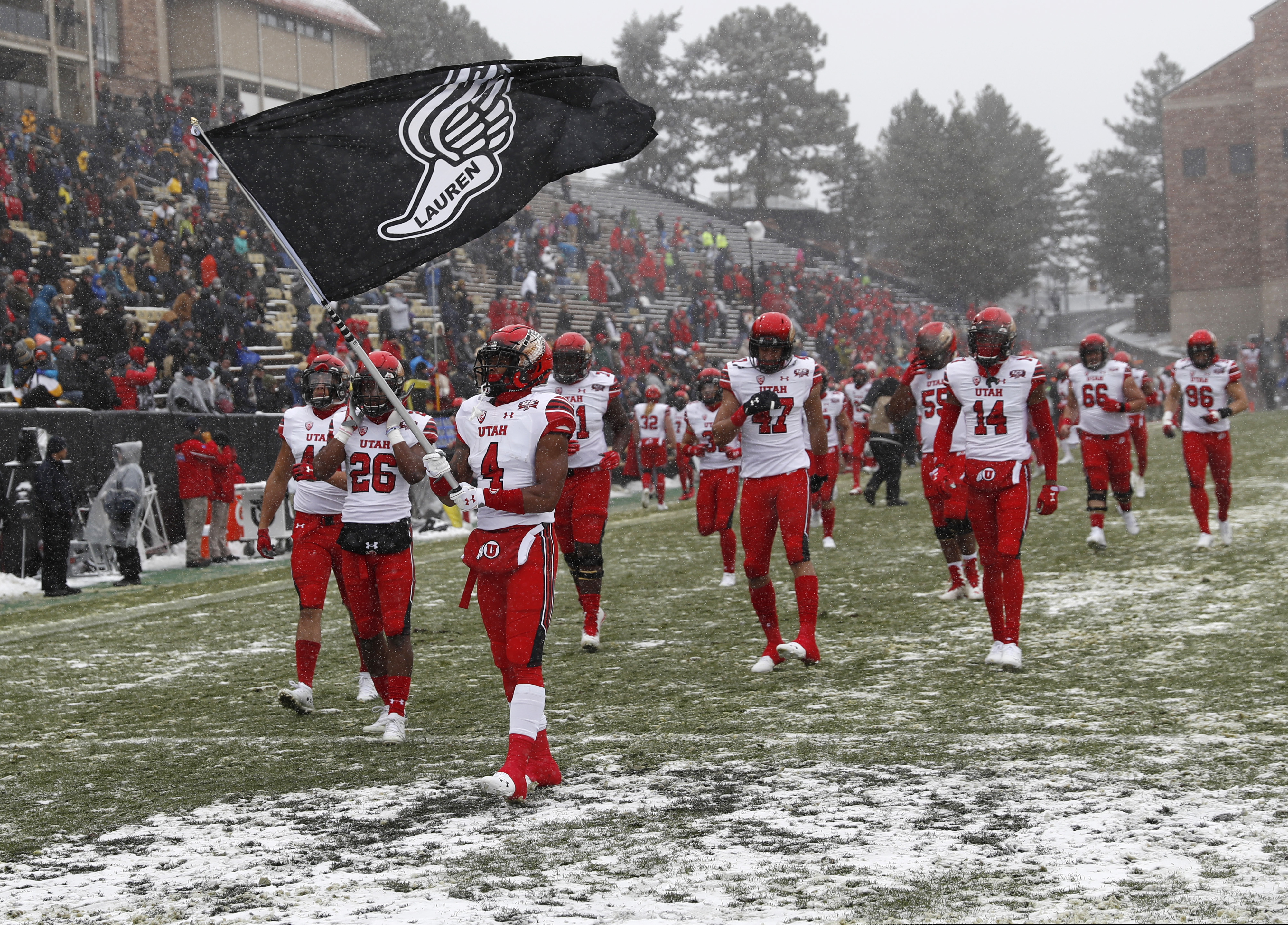 Utah running back TJ Green leads teammates on to the field to face Colorado in the first half of an NCAA college football game Saturday, Nov. 17, 2018, in Boulder, Colo. (AP Photo/David Zalubowski)
