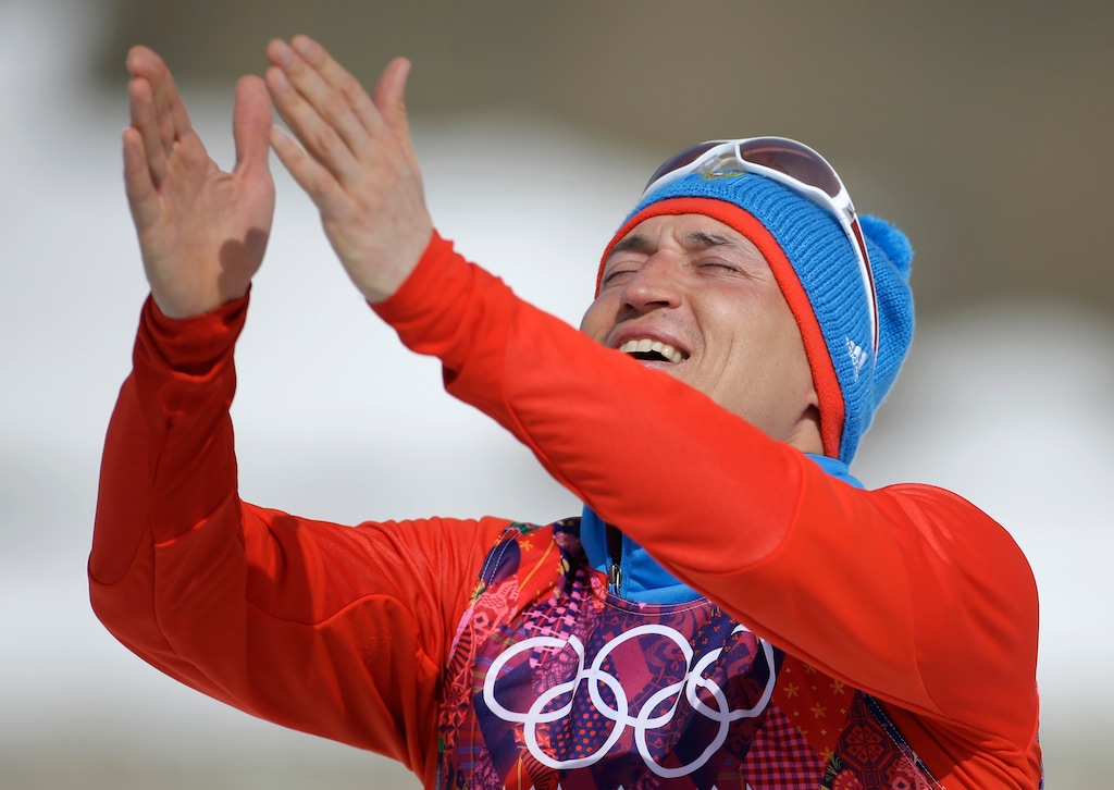 FILE- In this Sunday, Feb. 23, 2014 file photo, Russia's gold medal winner Alexander Legkov gestures to the crowd during the flower ceremony of the men's 50K cross-country race at the 2014 Winter Olympics in Krasnaya Polyana, Russia. The International Olympic Committee said Wednesday, Nov. 1st, 2017, cross-country skier Alexander Legkov has been disqualified from all his events at Sochi. Legkov won an individual gold medal and relay silver. (AP Photo/Gregorio Borgia, File)