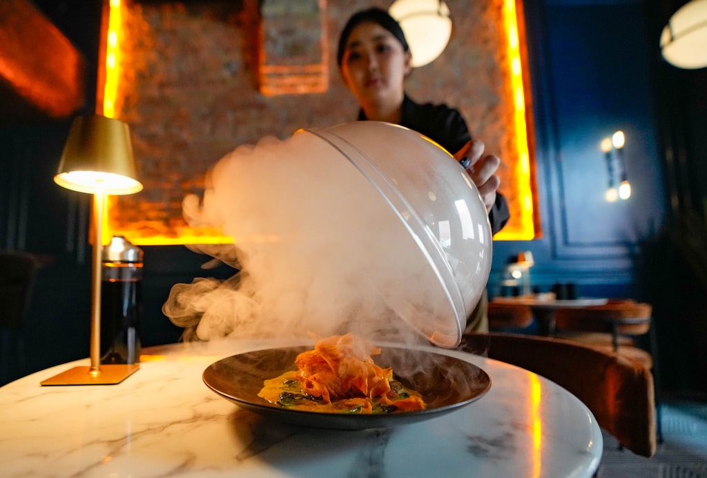 (Francisco Kjolseth | The Salt Lake Tribune) Nomi Battulga removes the lid on a smoked Atlantic Salmon at Gossip Kitchen in downtown Salt Lake City, Monday, June 8, 2026.
