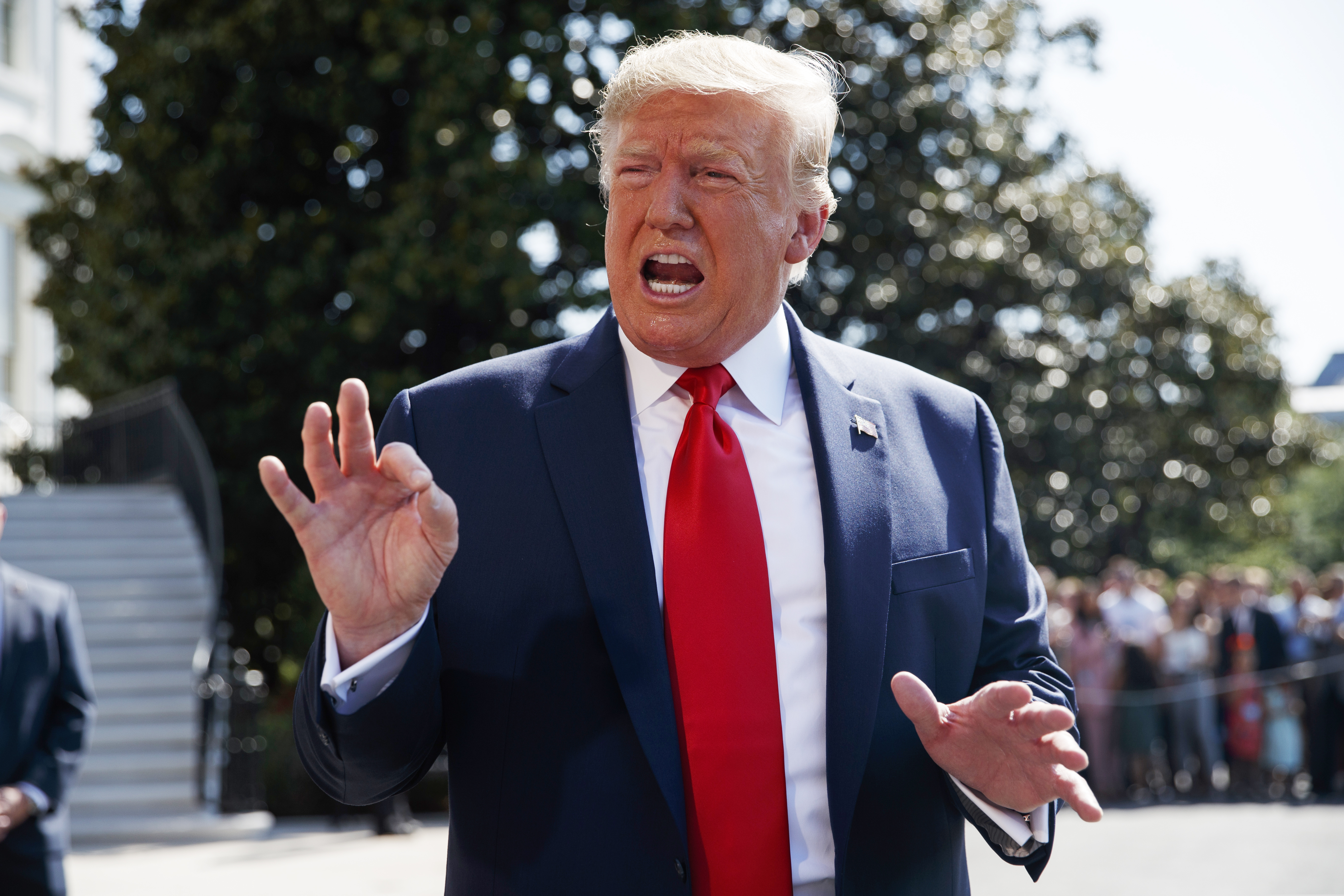 (Evan Vucci | AP) President Donald Trump talks to reporters on the South Lawn of the White House, Friday, Aug. 9, 2019, in Washington, as he prepares to leave Washington for his annual August holiday at his New Jersey golf club.