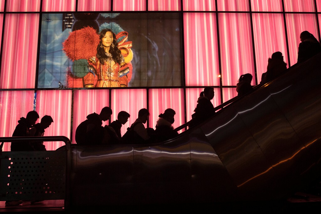 (Ng Han Guan | AP) Shoppers at a retail district pass by an American lingerie company Victoria's Secret store in Beijing on Friday, Dec. 13, 2019. China deputy trade envoy says China and the U.S. have reached a trade deal, will reduce punitive tariffs on each other's goods.