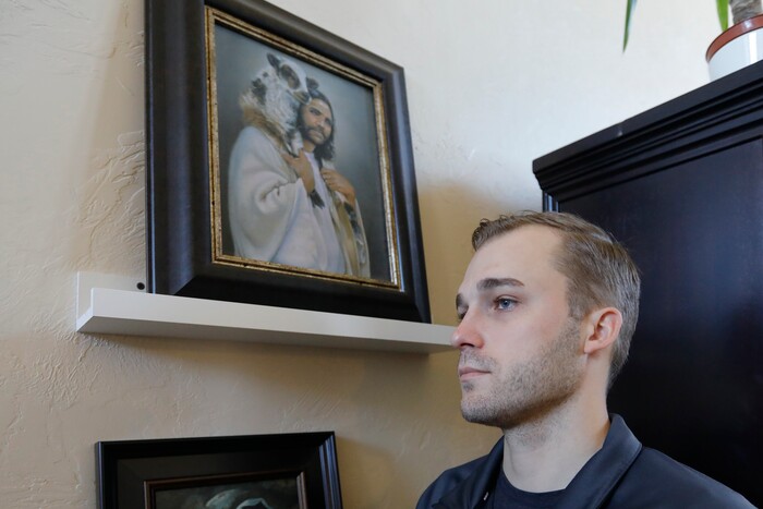 Austin Cloes, a Utah relative of the Americans killed in Mexico in what appears to be an attack by the cartels, poses for a photograph during an interview Tuesday, Nov. 5, 2019, in Herriman, Utah. Drug cartel gunmen ambushed three SUVs along a dirt road, slaughtering at least six children and three women all of them U.S. citizens living in northern Mexico in a grisly attack that left one vehicle a burned-out, bullet-riddled hulk, authorities said Tuesday, Nov. 5, 2019. (AP Photo/Rick Bowmer)