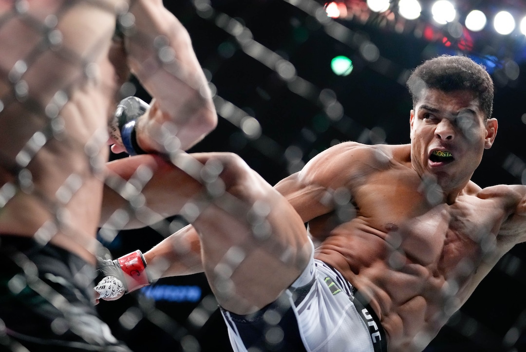 (Francisco Kjolseth | The Salt Lake Tribune) No. 6 ranked middleweight Paulo Costa of Brazil, right, faces former middleweight champion Luke Rockhold of the United States during their UFC 278 mixed martial arts bout in the octagon at Vivint Arena in Salt Lake City on Saturday, Aug. 20, 2022. 