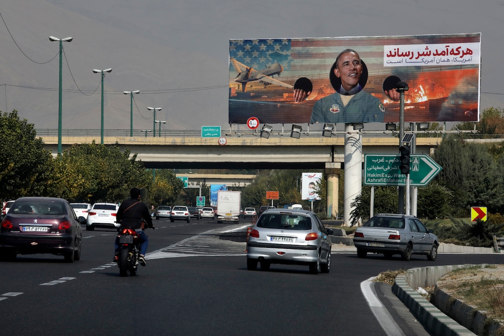 Vehicles drive on a highway under an anti-U.S. billboard with a portrait of former President Barack Obama, in Tehran, Iran, Tuesday, Nov. 3, 2020. (AP Photo/Vahid Salemi)