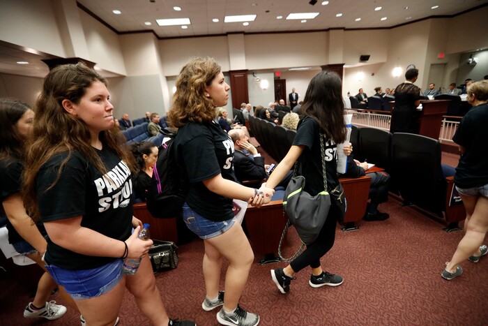 Student survivors from Marjory Stoneman Douglas High School, where over a dozen students and faculty were killed in a mass shooting on Wednesday, enter a house legislative committee hearing, to interrupt and challenge lawmakers on gun control reform, in Tallahassee, Fla., Wednesday, Feb. 21, 2018. (AP Photo/Gerald Herbert)