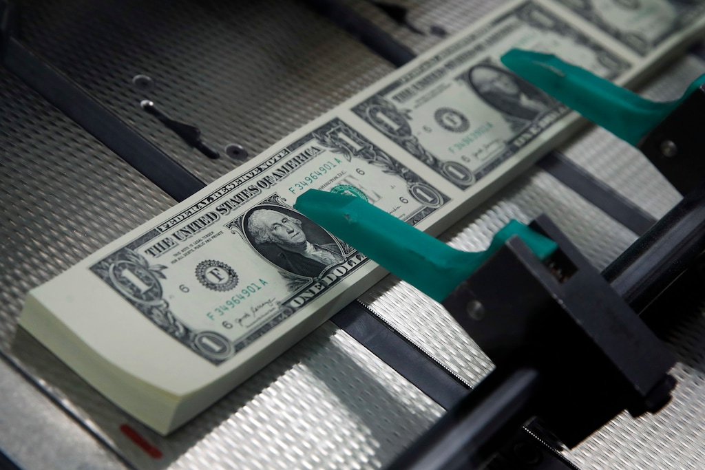 (Jacquelyn Martin | The Associated Press) In this Nov. 15, 2017, file photo, new $1 bills with the signatures of U.S. Treasurer Jovita Carranza and Treasury Secretary Steven Mnuchin are cut and stacked at the Bureau of Engraving and Printing in Washington. There’s a finite list of things you can change at work, and your employer’s less-than-stellar retirement plan probably isn’t among them. An individual retirement account can provide comparable tax benefits to a 401(k), but with a broader array of assets and generally lower associated fees.