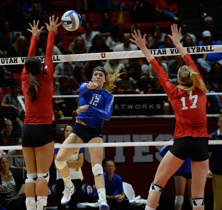 Francisco Kjolseth | The Salt Lake TribuneBYU's Veronica Jones threads the ball between Utah players Eliza Katoa, left, and Brenna DeYoung in the annual meeting between the schools' women's volleyball teams at Utah. 