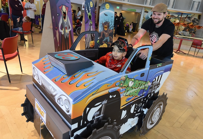 (Francisco Kjolseth  |  The Salt Lake Tribune)  Jonathan Clark, 6, tries out his new monster truck conversion as his dad, Jeremy, pushes him around at Shriners Hospital for Children in Salt Lake on Wednesday, Oct. 17, 2018. For the third year in a row, volunteers and staff transformed the wheelchairs of 28 patients for Halloween.