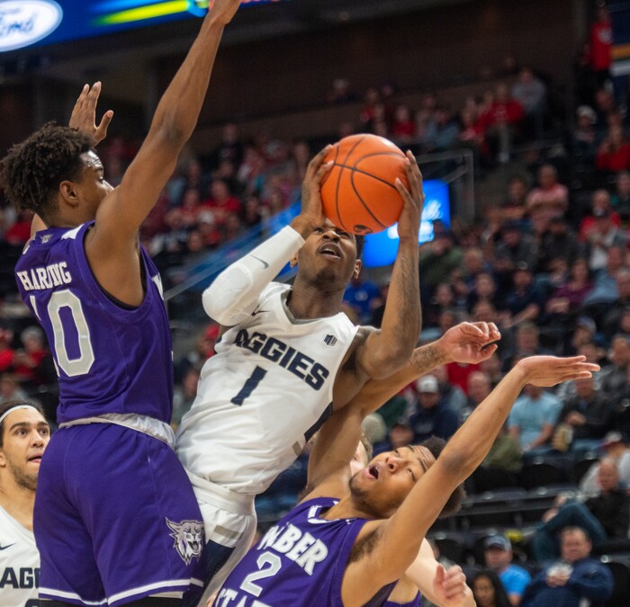 (Rick Egan  |  The Salt Lake Tribune)   Utah State Aggies guard Tauriawn Knight (1) shoots as Weber State Wildcats guard Jerrick Harding (10) and Weber State Wildcats guard Ricky Nelson (2) defend,  in basketball action in the Beehive Classic, between against the Utah State Aggies and Weber State Wildcats, a the Vivint Smart Home Arena, Saturday December 8, 2018.

 