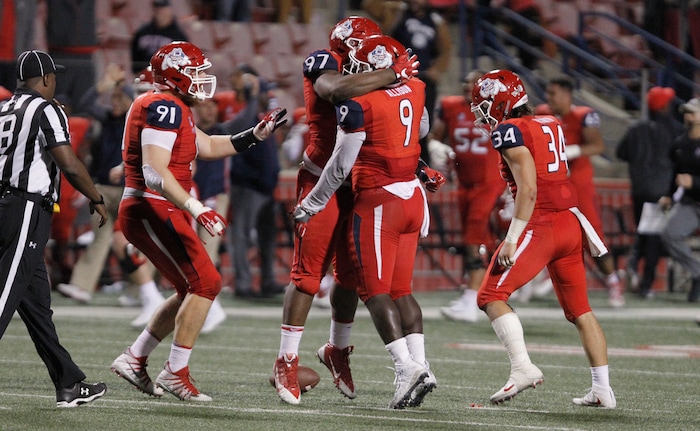 Fresno State's Malik Forrester (97) and Jeffrey Allison (9) celebrate an interception to clinch the game against BYU during the second half of an NCAA college football game in Fresno, Calif., Saturday, Nov. 4, 2017. Fresno State won the game 20-13. (AP Photo/Gary Kazanjian)