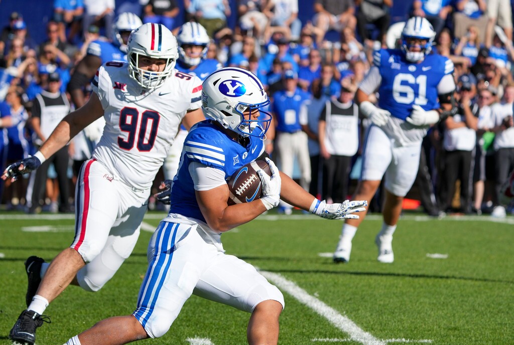 (Bethany Baker  |  The Salt Lake Tribune) Brigham Young Cougars running back LJ Martin (27) runs the ball during the game between the Brigham Young Cougars and the Arizona Wildcats in Provo on Saturday, Oct. 12, 2024.