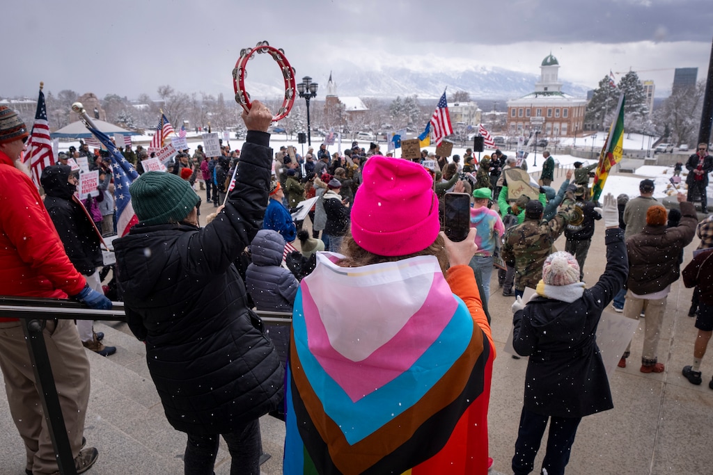 (Rick Egan | The Salt Lake Tribune) A woman wears a pride flag as veterans and supporters gather at the Capitol in Salt Lake City for a protest in response to Trump administration policies on Friday, March 14, 2025.