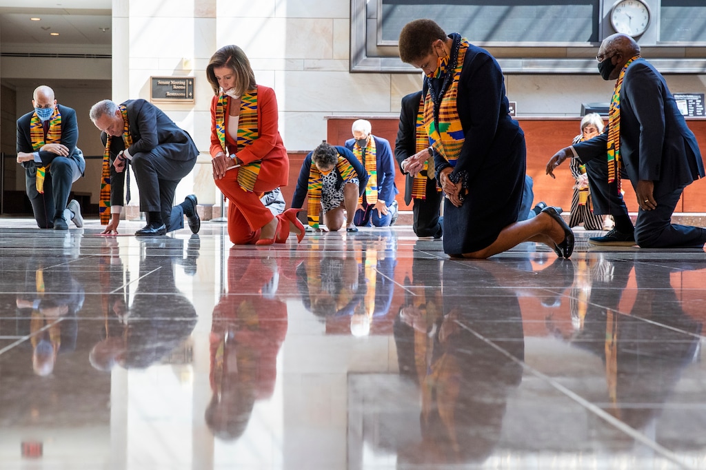 (Manuel Balce Ceneta | AP) House Speaker Nancy Pelosi of Calif., center, and other members of Congress, kneel and observe a moment of silence at the Capitol's Emancipation Hall, Monday, June 8, 2020, on Capitol Hill in Washington, reading the names of George Floyd and others killed during police interactions. Democrats proposed a sweeping overhaul of police oversight and procedures Monday, an ambitious legislative response to the mass protests denouncing the deaths of black Americans at the hands of law enforcement.