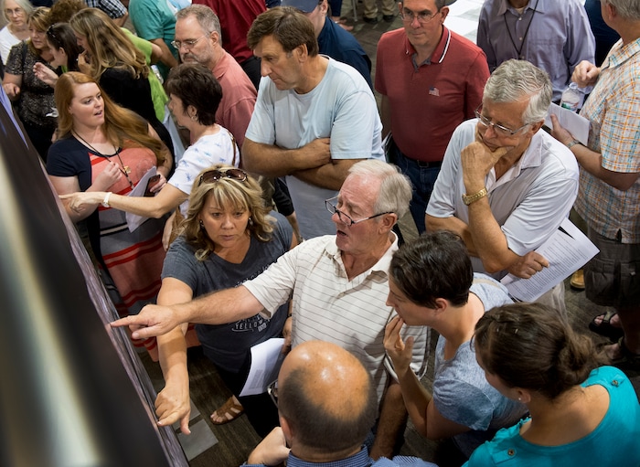 (Leah Hogsten | The Salt Lake Tribune) "When has growth ever done anything for me?" said Bruce Young, center, talking with other concerned Davis County citizens.
Utah Department of Transportation (UDOT) representatives fielded hundreds of questions from concerned Davis County residents seeking information about the US-89 State Environmental Study and the proposal to convert US-89 in Davis County into a freeway. The formal public comment period continues through Monday September 25.