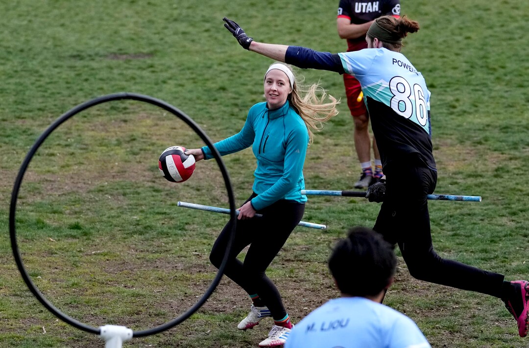 (Francisco Kjolseth | The Salt Lake Tribune) Katie Ely runs the quaffle (a volleyball) as she looks for an opening to score while Mikey Powell puts on defensive pressure while playing Quidditch at Reservoir Park in Salt Lake City on Wednesday, April 13, 2022. 