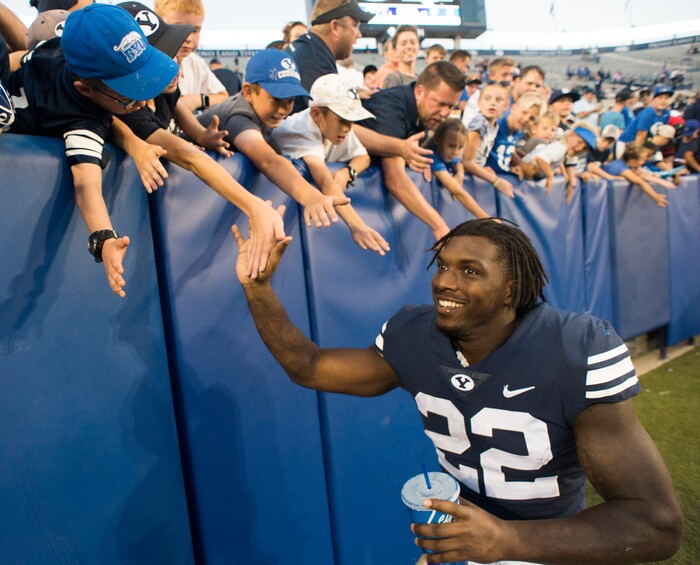 (Rick Egan  |  The Salt Lake Tribune)    Brigham Young Cougars running back Squally Canada (22) high-fives the crowd after the Brigham Young Cougars defeated the McNeese State Cowboys 30-3, at Lavell Edwards Stadium, Saturday, Sept. 22, 2018.


