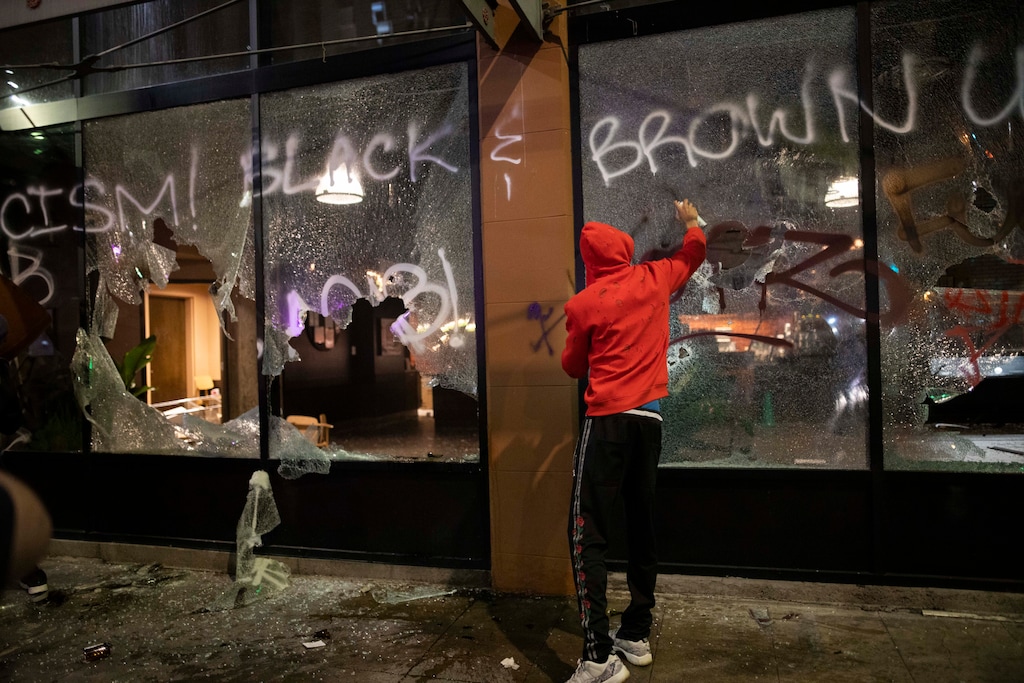 (Christian Monterrosa | AP file photo)

In this May 29 photo, protesters loot and vandalize a Starbucks as they clash with police officers during a protest in downtown Los Angeles. Members of the "Safe LA Task Force" announced on Wednesday arrests for arson, looting, assault and vandalism, among other crimes, that occurred during protests against police brutality in the Los Angeles region.
