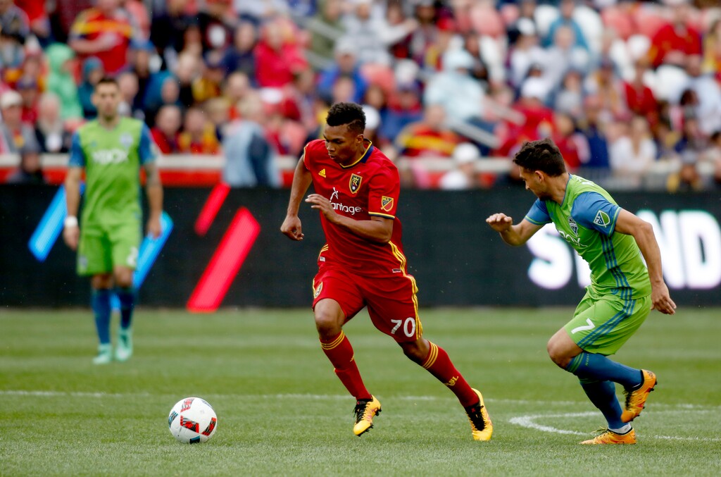 Real Salt Lake's Jordan Allen (70) dribbles the ball as Seattle Sounders' Cristian Roldan (7) defends during the second half of an MLS soccer game on Saturday, March 12, 2016, in Sandy, Utah.  (AP Photo/Kim Raff)

