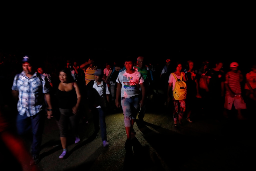 (Moises Castillo  |  AP Photo) In this Oct. 24, 2018, file photo, Central American migrants traveling with a caravan to the U.S., make their way to Mapastepec, Mexico. Militia groups and far-right activists are raising money and announcing plans to head to the Mexican border to help stop the caravan of Central Americans making their way toward the United States.