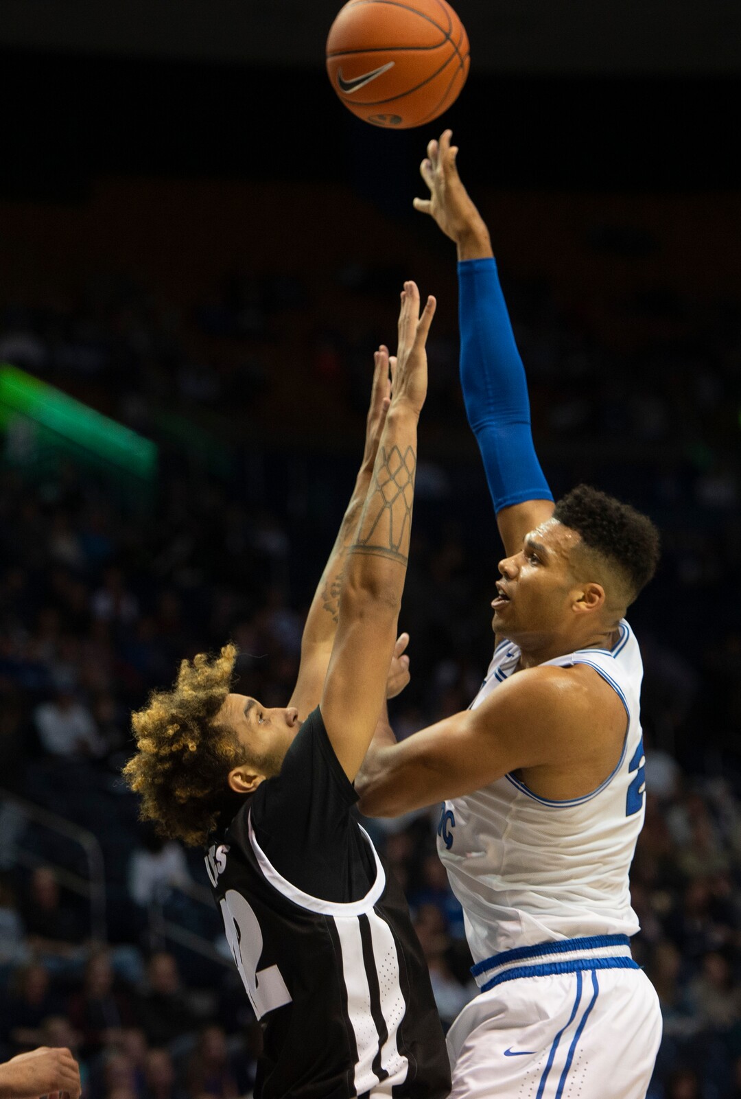 (Rick Egan  |  The Salt Lake Tribune)         Brigham Young Cougars forward Yoeli Childs (23)  shoots over Nevada Wolf Pack forward K.J. Hymes (42), in basketball action between the Brigham Young Cougars and the Nevada Wolf Pack, at the Marriott Center, in Provo, Saturday, December 10, 2019.