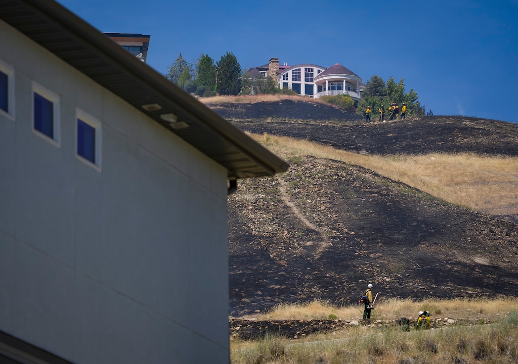 (Bethany Baker  |  The Salt Lake Tribune) Firefighters gather as they work to contain a brush fire near Ensign Peak in Salt Lake City on Wednesday, June 10, 2026.