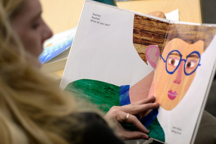 (Scott Sommerdorf   |  The Salt Lake Tribune)   
Laurie Clark, a Kindergarten teacher at Pioneer Elementary, reads during the banned book event at the County LibraryÕs Smith branch, Sunday, September 24, 2017. The public was invited to bring their favorite banned book to the Smith branch and participate in a Facebook live event where they would all read from their banned books, simultaneously, for approximately three minutes in celebration of our intellectual freedom. 