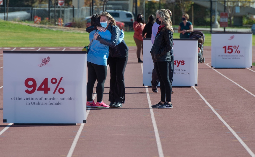 (Francisco Kjolseth  |  The Salt Lake Tribune) Jill McCluskey, center left, receives a warm embrace as she walks the track where her daughter Lauren used to compete, during a memorial walk on the two-year anniversary of her murder on Thursday, Oct. 22, 2020.