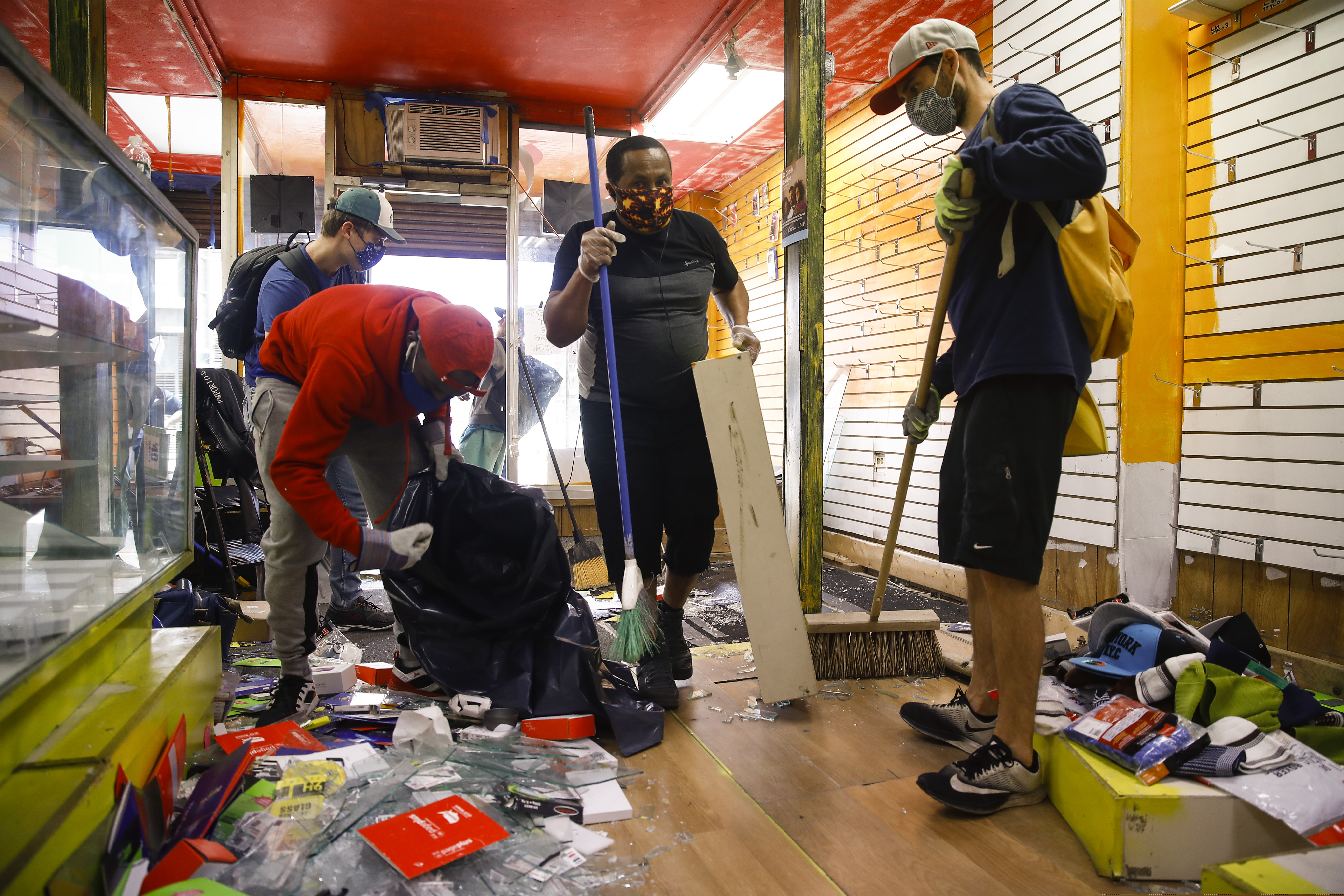(Matt Rourke | AP file photo) Volunteer community members clean up a looted store in Philadelphia, Monday, June 1, 2020, in the aftermath of protest and unrest in reaction to George Floyd's death while in police custody on May 25 in Minneapolis.