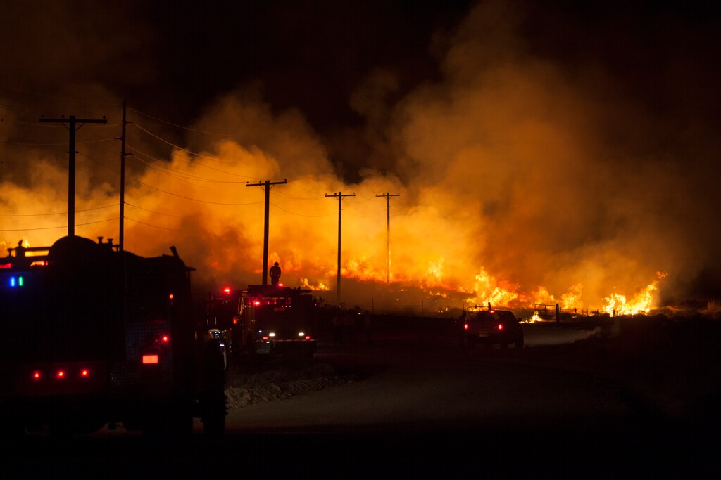 Firefighters work along the Old Dump Road off of Cottonwood Springs Road to monitor and contain a brush fire, Tuesday, July 14, 2020, in St George, Utah. (Chris Caldwell/The Spectrum via AP)