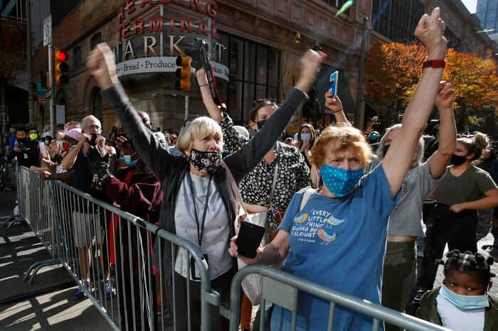 People celebrate outside the Pennsylvania Convention Center, Saturday, Nov. 7, 2020, in Philadelphia, after Democrat Joe Biden defeated President Donald Trump to become 46th president of the United States. (AP Photo/Rebecca Blackwell)