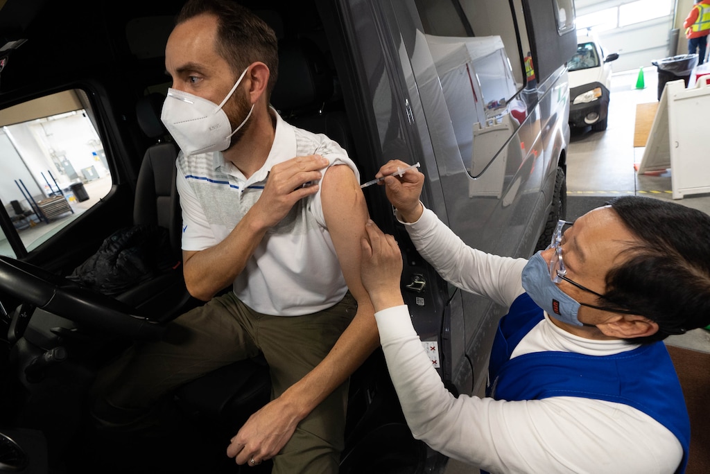 (Francisco Kjolseth  | The Salt Lake Tribune) Nate Marine gets his first COVID-19 vaccination from Dr. Emil Chuang at the Utah Film Studios in Park City on Thursday, March 18, 2021. 
