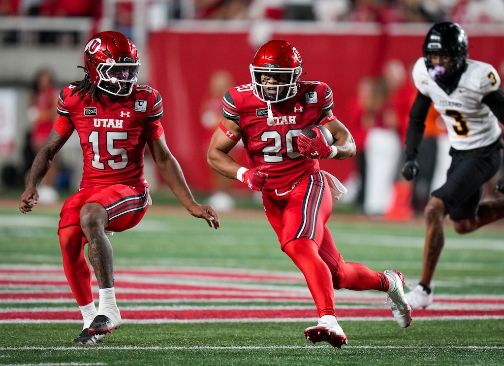 (Bethany Baker  |  The Salt Lake Tribune) Utah Utes running back Mateaki Helu (20) runs the ball as Utah Utes quarterback Byrd Ficklin (15) looks on during the second half of the game between the Utah Utes and the Idaho Vandals at Rice-Eccles Stadium in Salt Lake City on Thursday, Sept. 3, 2026.