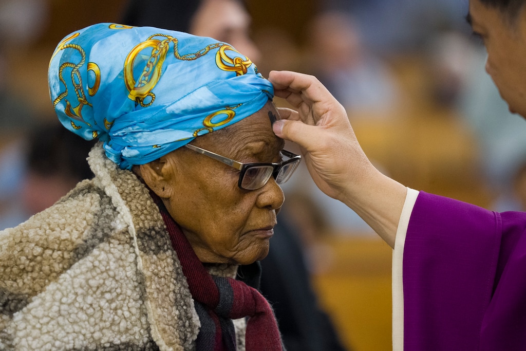 (Bethany Baker  |  The Salt Lake Tribune) Alice Osheku, from Nigeria visiting family, receives ashes for Ash Wednesday at St. Ann Catholic Church in South Salt Lake on Wednesday, Feb. 18, 2026.