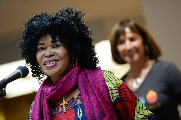 (Francisco Kjolseth  |  The Salt Lake Tribune)  Rosette Rwaminigiho who fled the Congo with her children after losing her husband, sister and business to war, proudly says a few words during the Women of the World's 8th annual award ceremony at the Salt Lake County building in Salt Lake City on Saturday, Dec. 8, 2018. Working hard to learn English and achieve U.S. citizenship, Rwamigiho joined 24 other women in receiving certificates as a celebration of successes including educational, service, and employment milestones by refugee women.