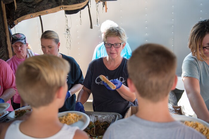 (Rachel Molenda  |  The Salt Lake Tribune)  Laurie Clayton, of Moab, Utah, hands out food in Kountze, Texas, on Tuesday, Sept. 5, 2017. Laurie Clayton, along with her husbad John Clayton and daughter Emma Clayton, drove their Sunset Grill mobile kitchen to the town to provide meals for those impacted by Hurricane Harvey.