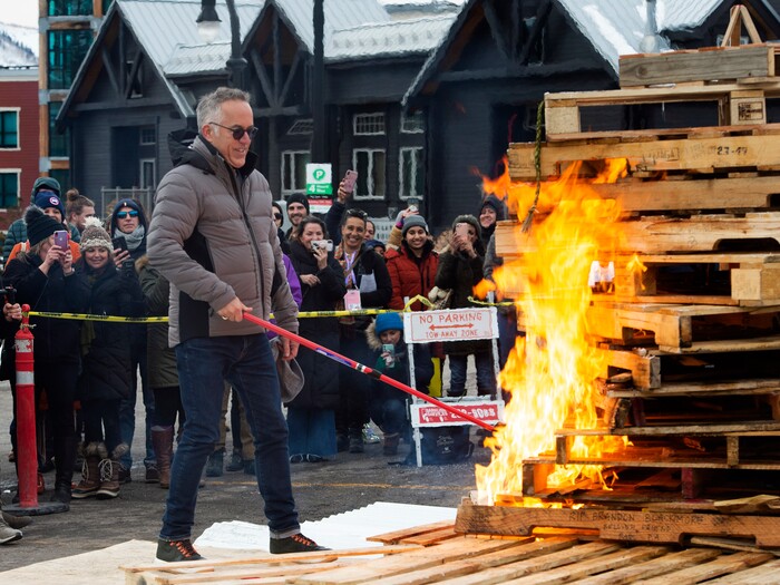 (Rick Egan  |  The Salt Lake Tribune)      John Cooper, the festival's director, lights the first-ever Sundance bonfire, a community gathering on Swede Alley, in Park City, Thursday, Jan. 30, 2020.