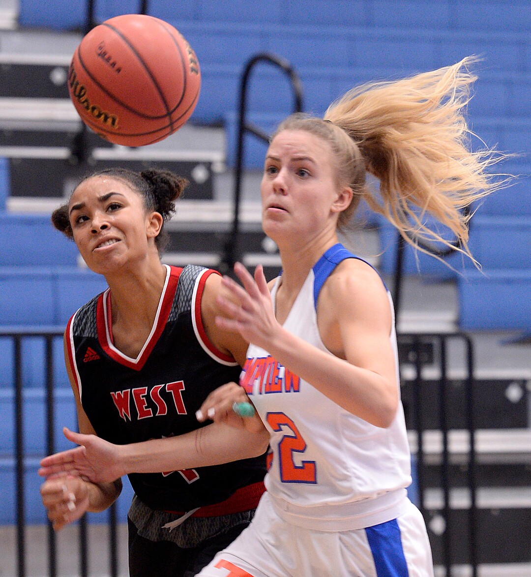 (Al Hartmann  |  The Salt Lake Tribune) 	West High School's Abena BakenRa, left, and Timpview's Kennedy White go for the ball in the Class 5 girls' basketball playoff game Monday Feb. 19 2018