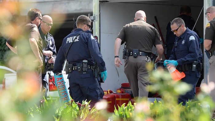 (Francisco Kjolseth  |  The Salt Lake Tribune)  Police gather evidence, including arm lock tubes with the words "ABOLISH ICE" after activists staged a protest against a private prison company with contracts to hold undocumented immigrants on Thursday, July 12, 2018, at the headquarters of Management and Training Corporation in Centerville.
